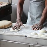 man preparing dough for bread