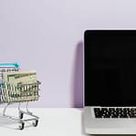 shopping cart next to a laptop