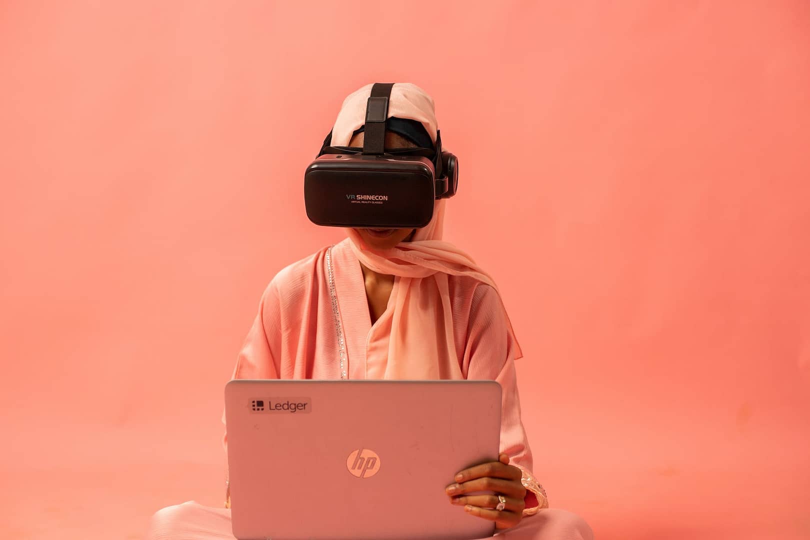 a woman with a laptop and a vr headset